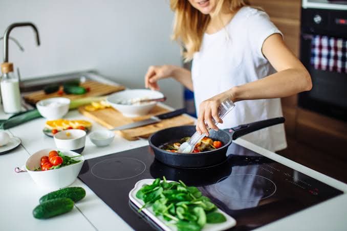 Foto de alguém cozinhando na cozinha